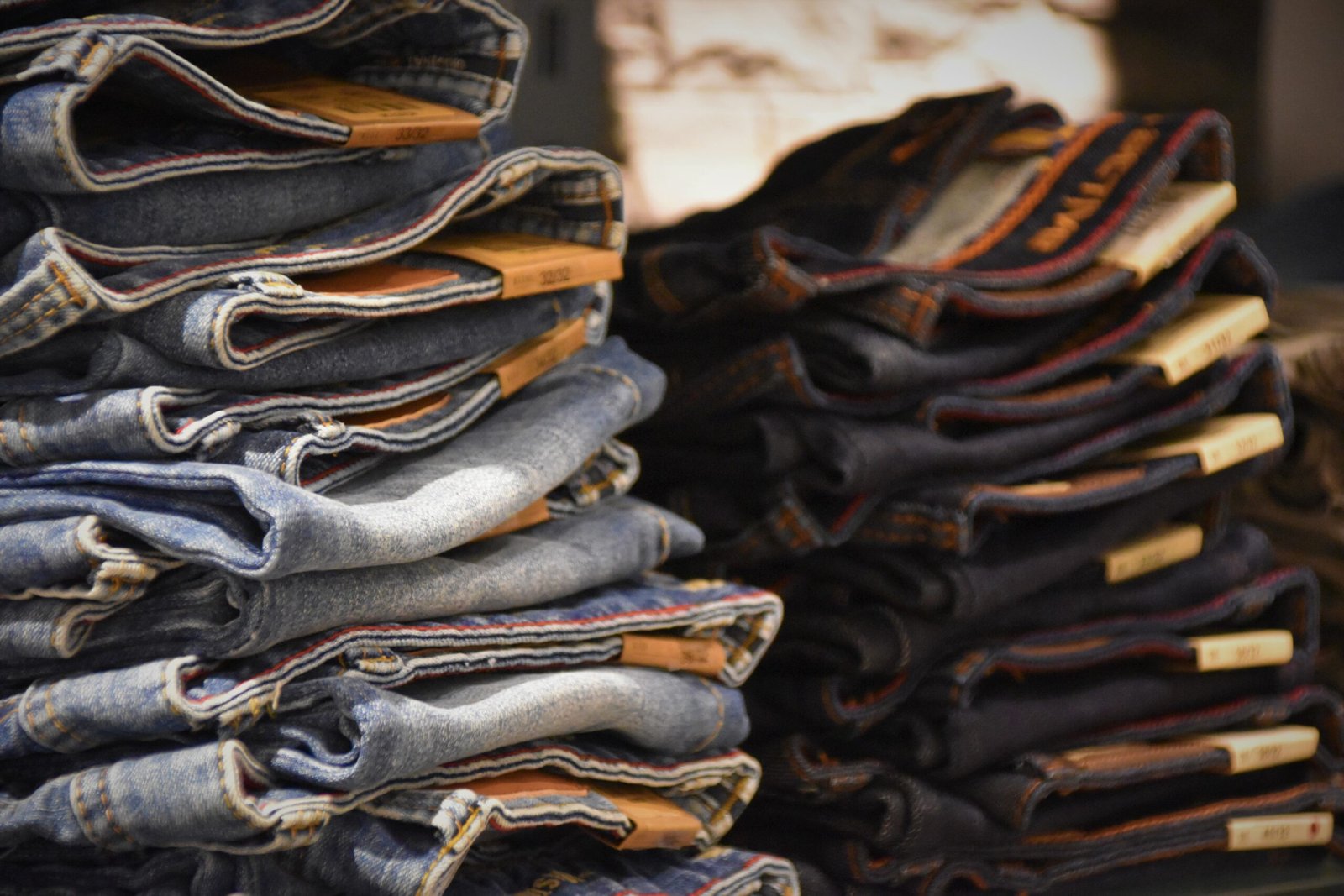 Folded denim jeans arranged in a retail store