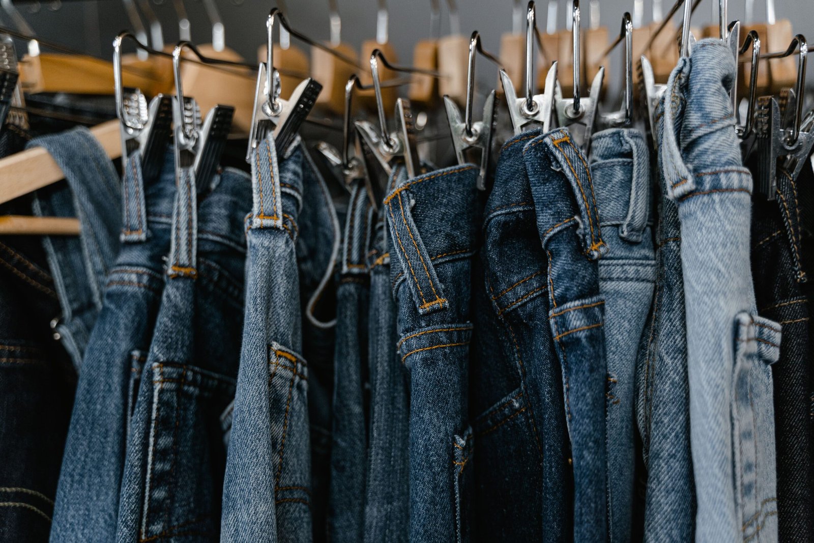 Close-up of denim jeans on a clothing rack Denim jeans displayed on a clothing rack